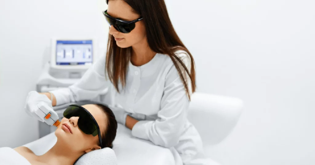 Woman receiving IPL laser treatment on the face from a skincare professional in Salt Lake City, UT